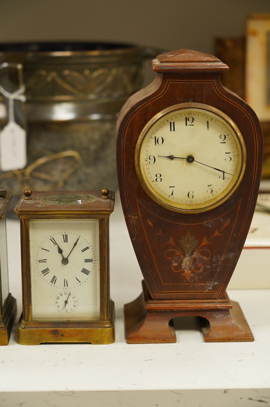 Two carriage clock, an Edwardian mantel clock, 25cm high, and a watch mounted in an oak case (4). Condition - fair, not tested for working